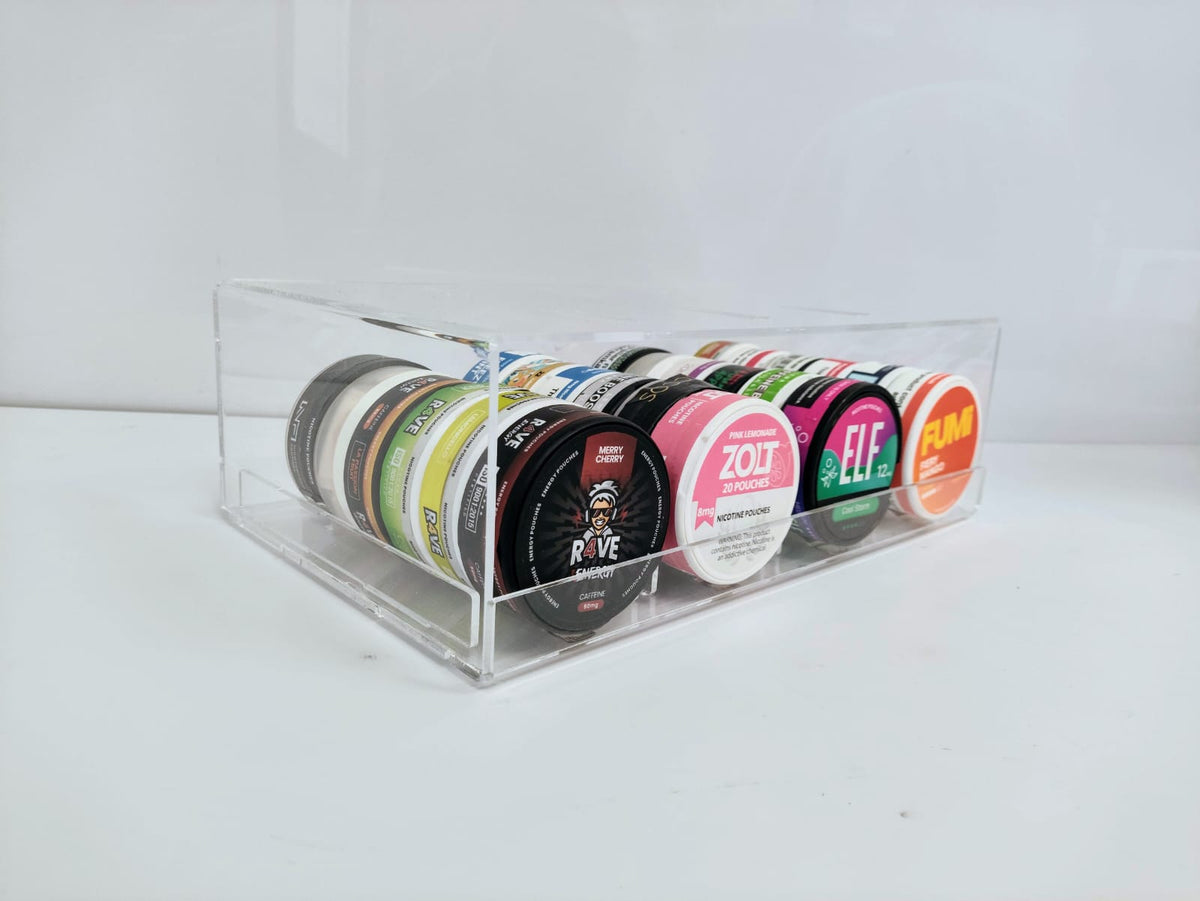 Clear acrylic nicotine pouch display stand with pushers, filled with four lanes of pouch cans