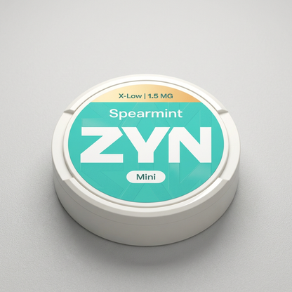 White ZYN Spearmint X-Low 1.5MG Mini Nicotine Pouches tin with teal and yellow label, featuring "Spearmint ZYN Mini" text.